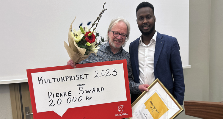 Maslah Omar (S),ordförande i kultur- och fritidsnämnden delade ut priset till en glad Pierre Swärd under kommunfullmäktiges sista sammanträde för året.